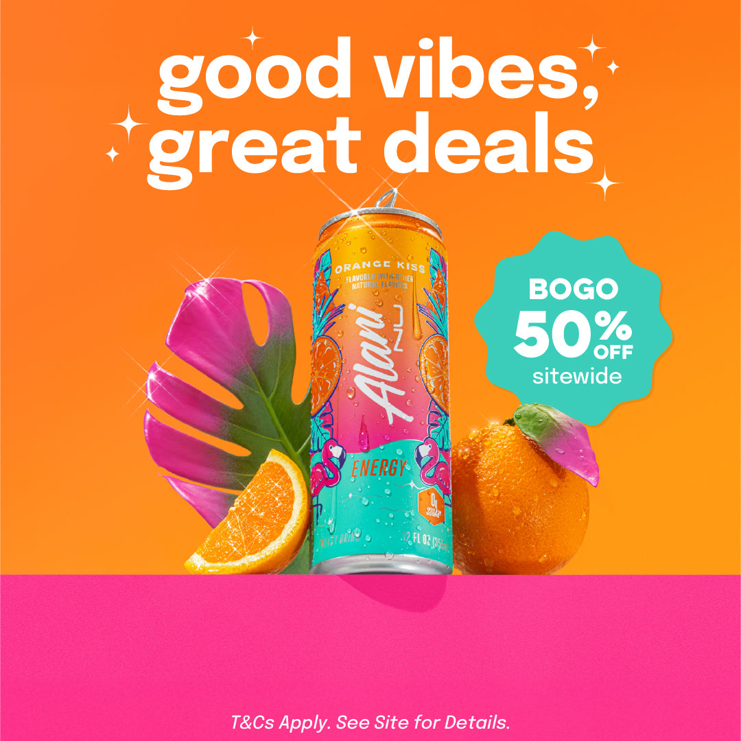 A sugar-free Orange Kiss Alani Nu Energy Drink sitting on a ledge surrounded by an orange, orange slice, and palm leaf.