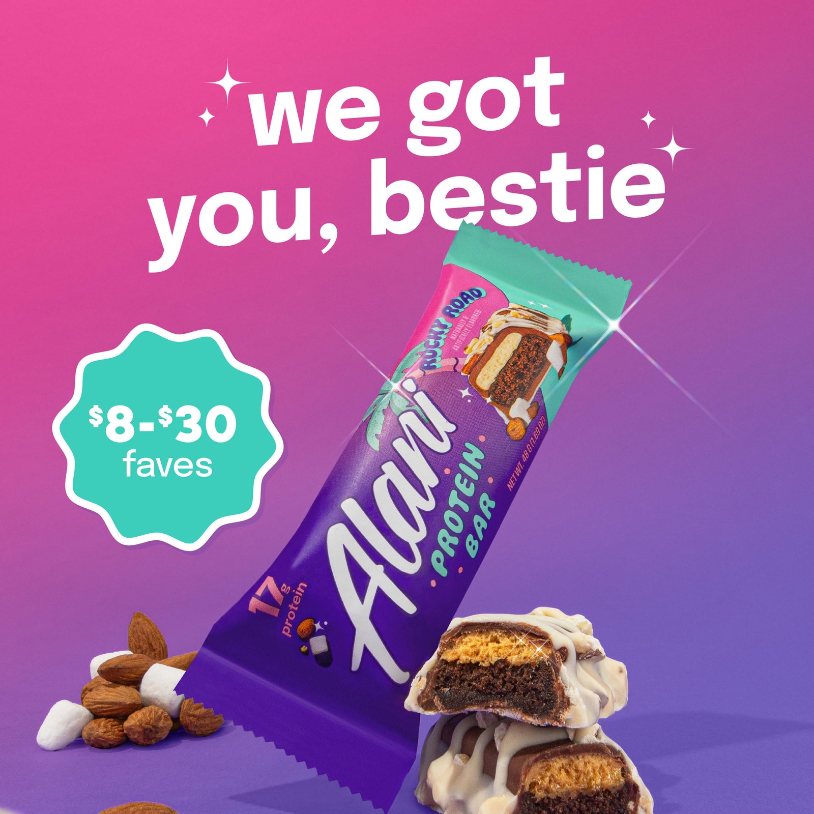 A Rocky Road Alani Nu Protein Bar is flanked by a grouping of chocolate, almonds, marshmallows and a bar cut in half to show the delicious interior.