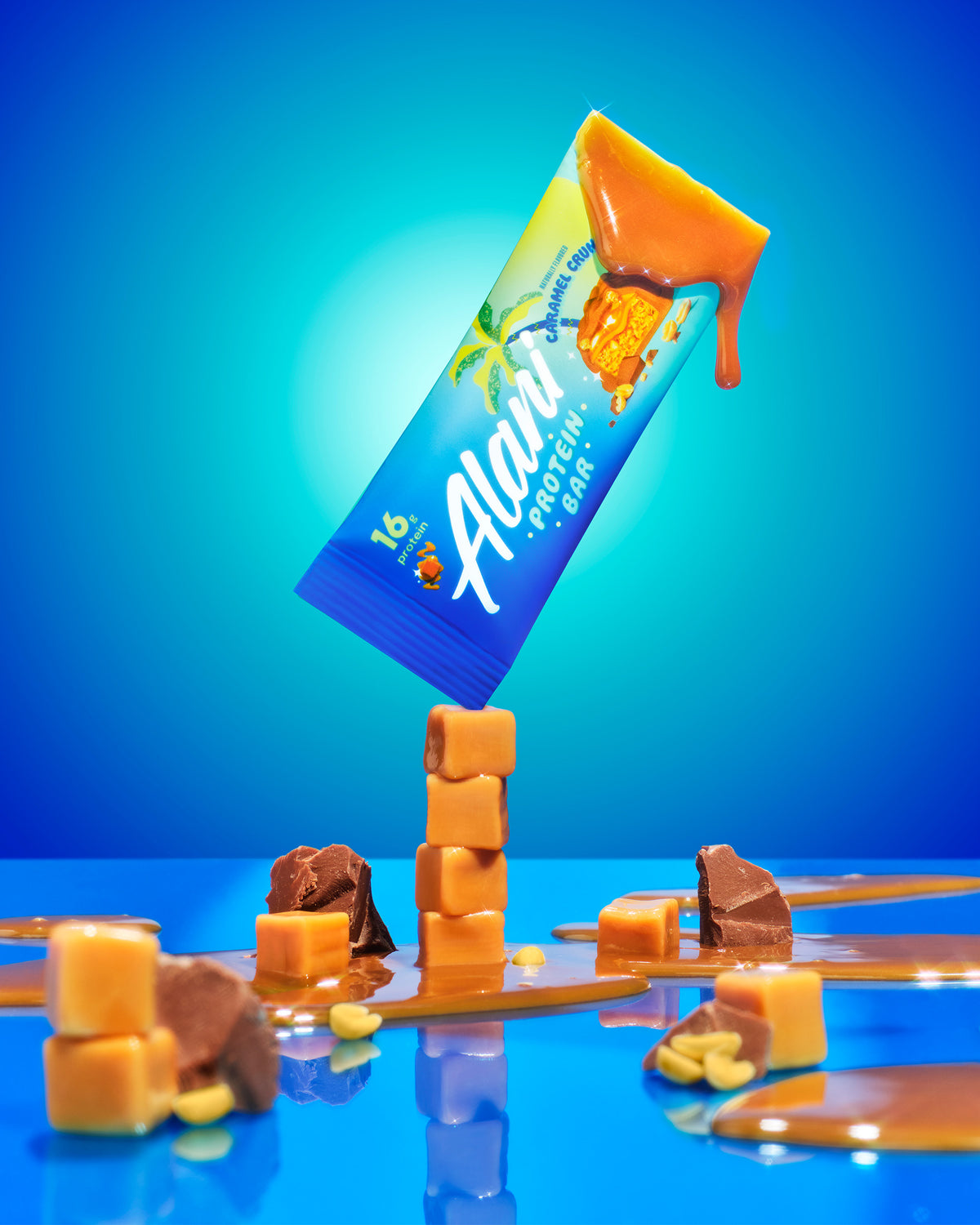 A Protein bar in Caramel Crunch flavor balancing on caramel cubes.
