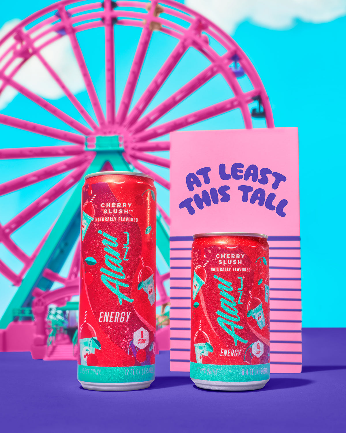 Mini Energy in Cherry Slush flavor next to a pink carousel fair ride. 
