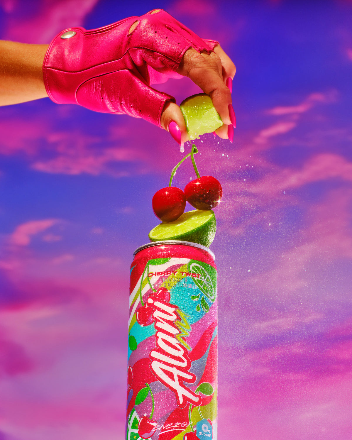 A gloved hand squeezes a lime over a can of Cherry Twist energy drink, adorned with cherries on top, against a dreamy sky backdrop with pink hues.