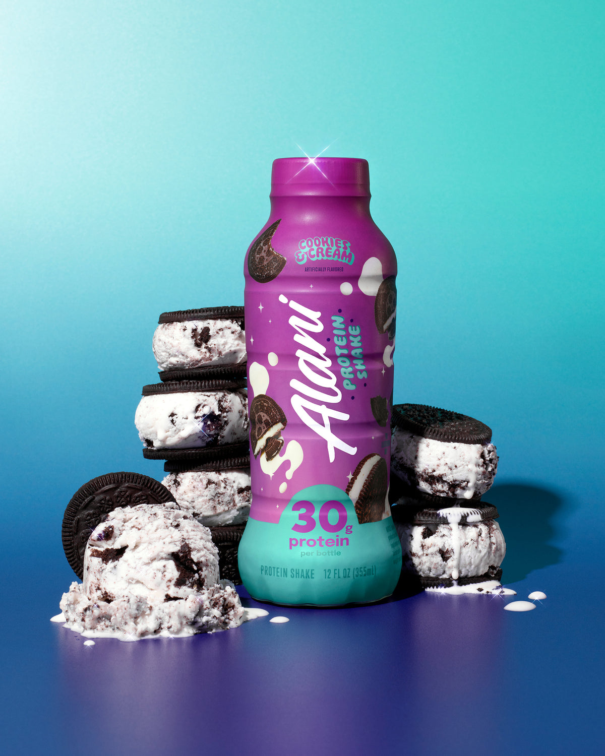 A bottle of Cookies & Cream rests amid chocolate sandwich cookies stuffed with creamy ice cream against a blue gradient background.