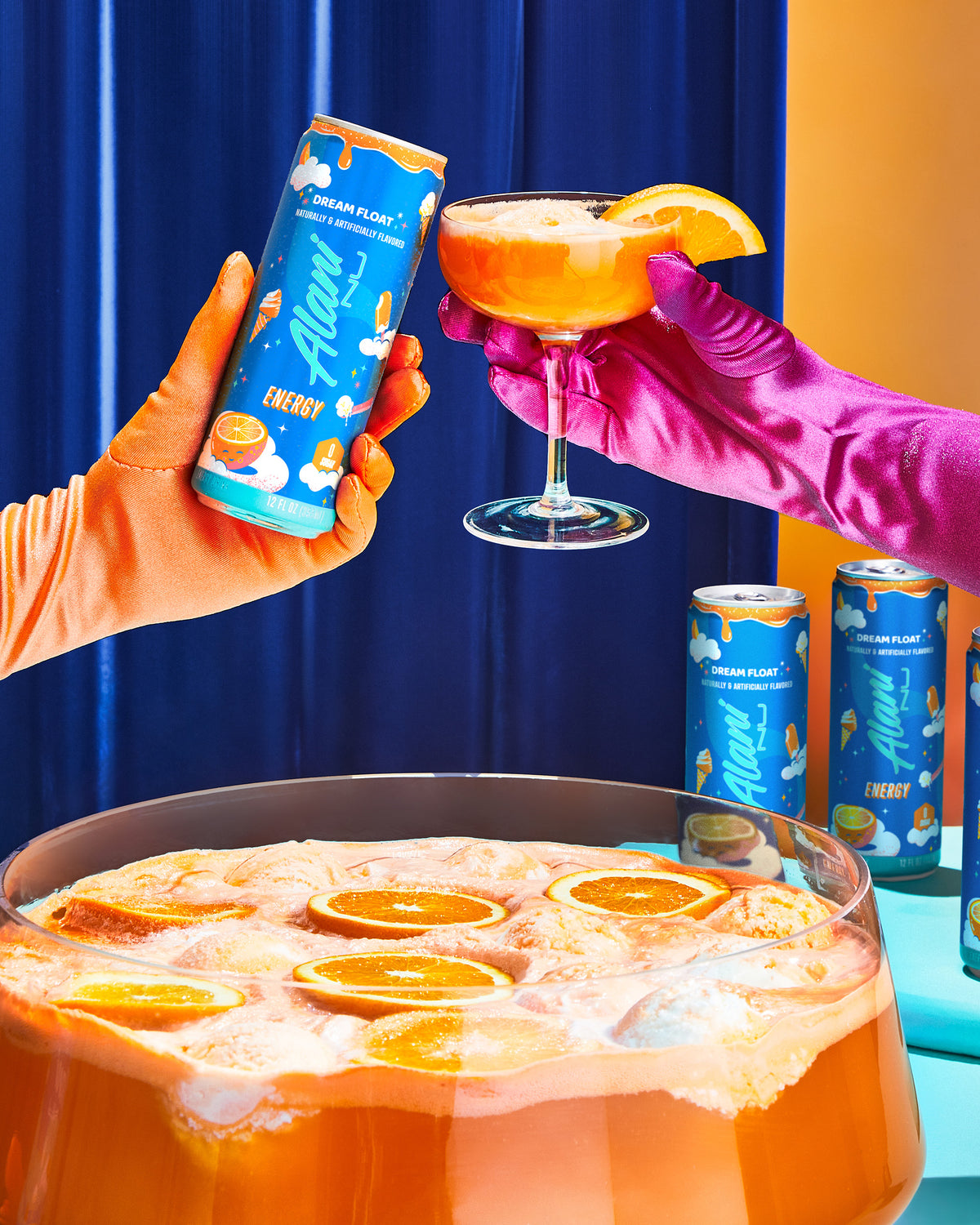 A energy drink in Dream Float flavor displayed next to person holding a glass filled with oranges and juice container.