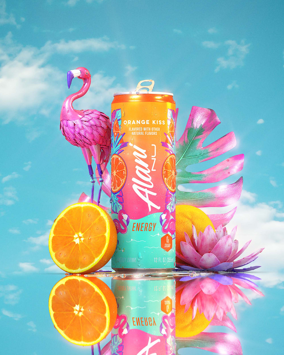 An Orange Kiss Energy Drink, flamingo sculpture, pink florals, and oranges in front of a blue sky.