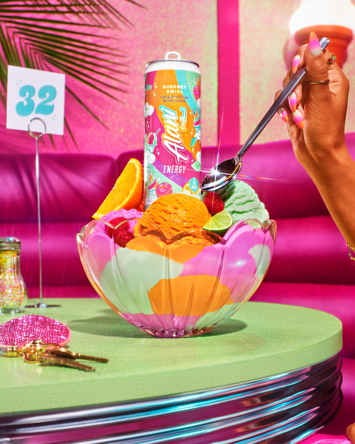 A woman seated at a booth enjoying a rainbow sherbet sundae garnished with fresh fruit and an Alani Nu Sherbet Swirl Energy Drink.
