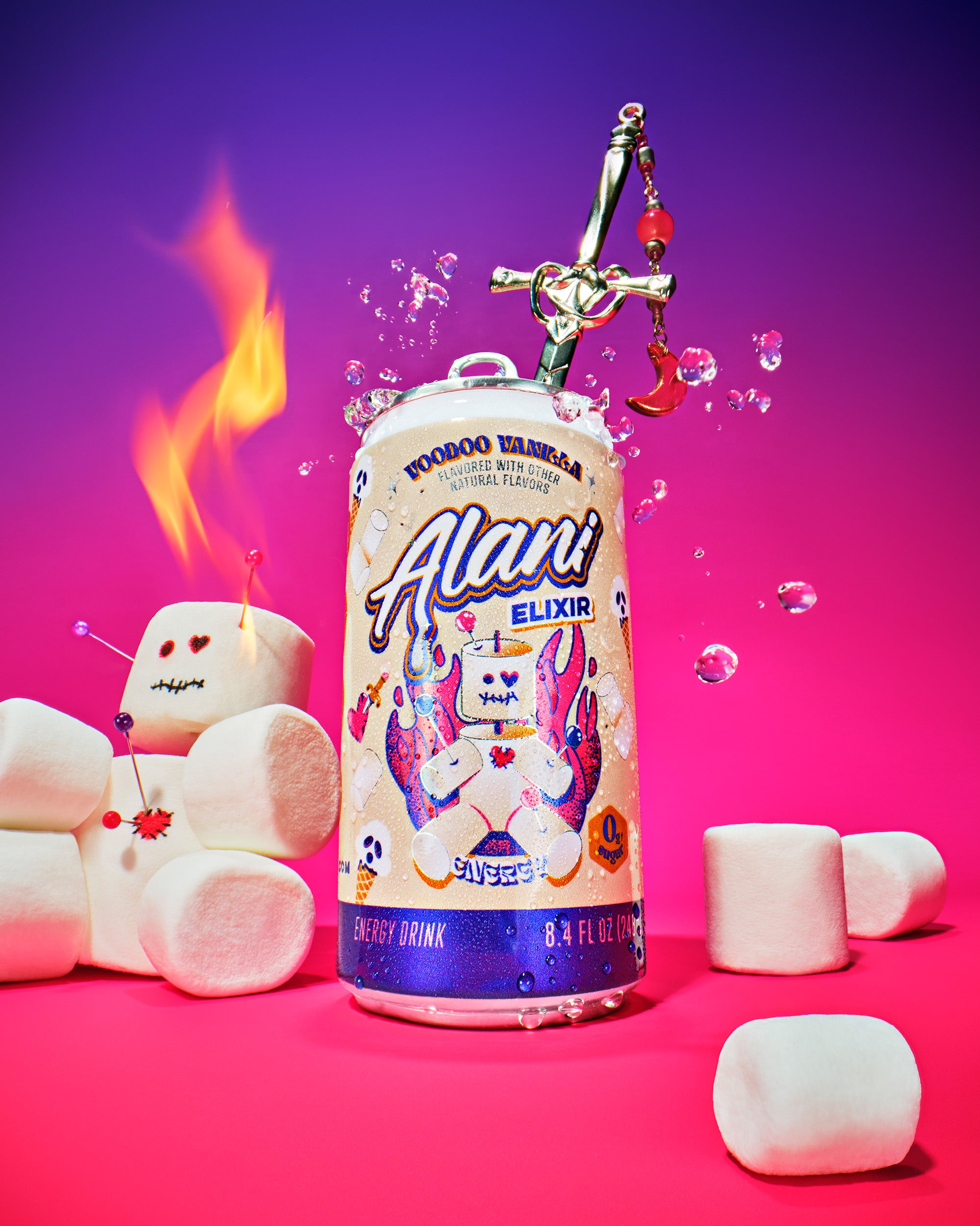 A can of Alani Voodoo Vanilla Energy Elixir centered with a jeweled sword stabbed through the top, surrounded by marshmallows and a marshmallow voodoo doll with pins in it, flames rising from it's head, and floating water droplets, set against a warm pink to purple gradient background.