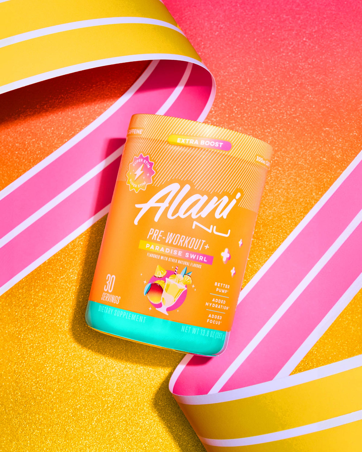 A container of Alani Nu Pre-Workout + - Paradise Swirl supplement in vibrant packaging with striped ribbons, positioned on a colorful background. The label highlights "30 servings, dietary supplement," with a net weight of 7.05 oz (200 g). Available at The Vitamin Shoppe.