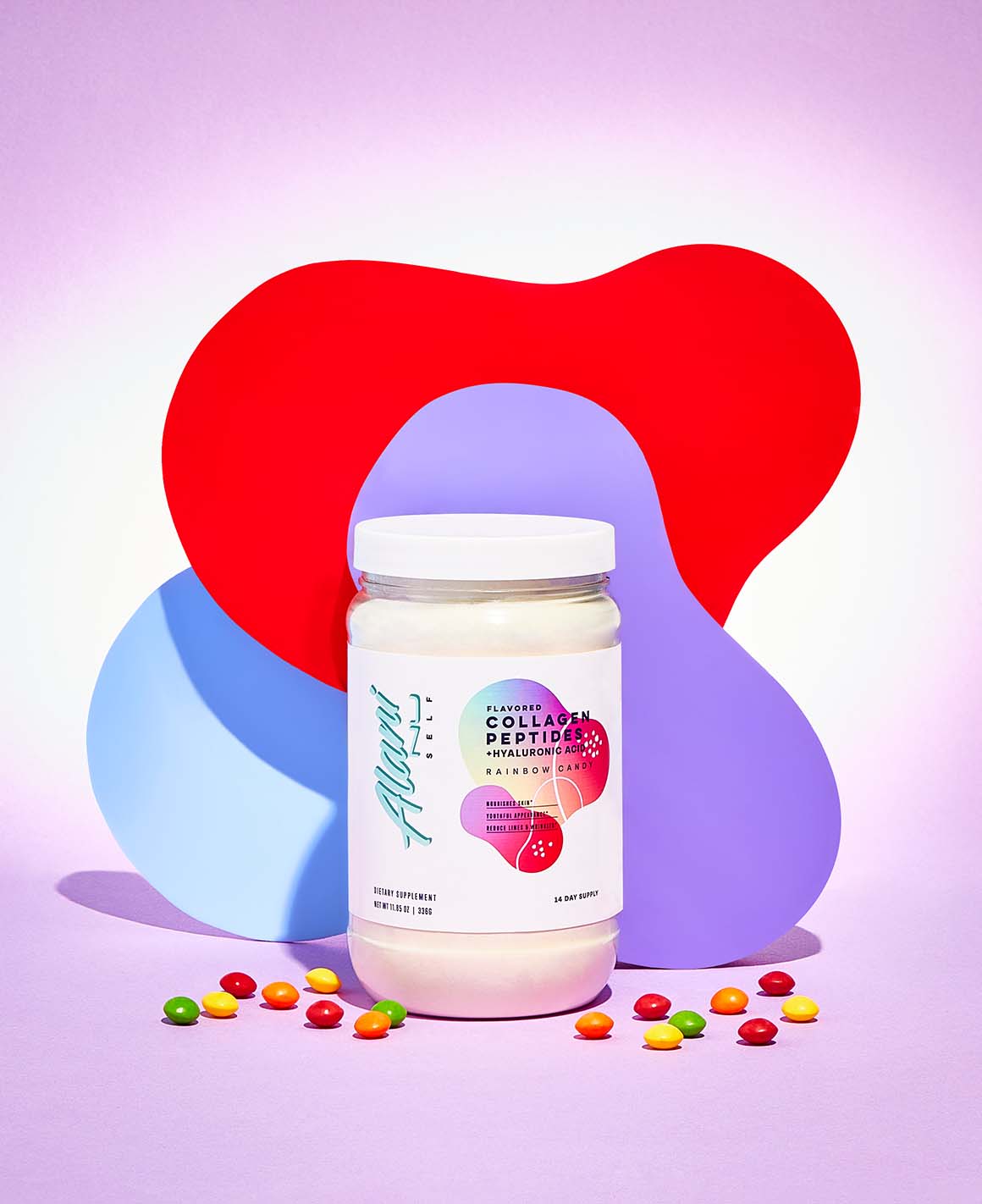 A container of Collagen Peptides in Rainbow Candy flavor sitting next to a pile of candy.