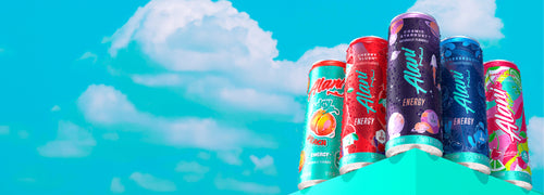 Juicy Peach, Cherry Slush, Cosmic Stardust, Breezeberry, and Cherry Twist Alani Nu Energy on a shelf in front of a blue sky. 