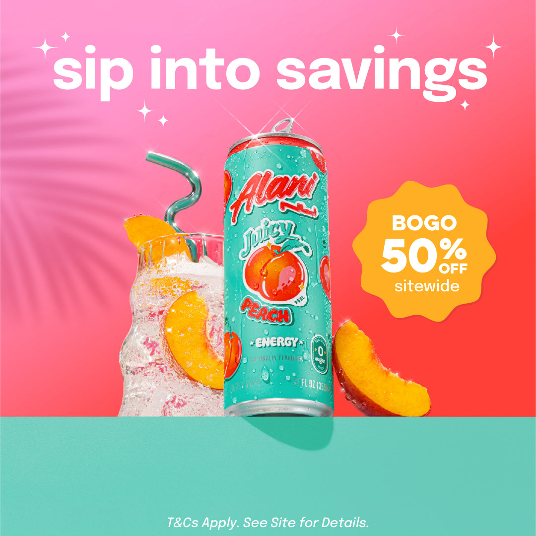 A sugar-free Juicy Peach Alani Nu Energy Drink sitting on a ledge surrounded by a peaches and a glass filled with Juicy Peach Energy.