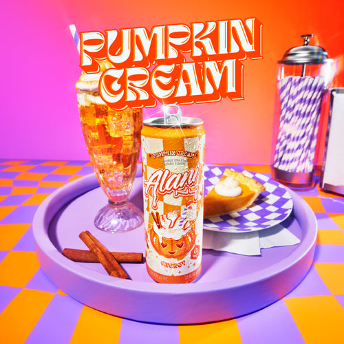 Alani's new fall Energy Drink on a serving tray with 2 cinnamon sticks, a pumpkin cream soda float, and a slice of pie. Text reads, "Pumpkin Cream."
