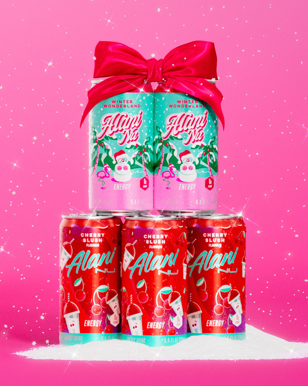 A bow-topped tower of Alani Nu's zero-sugar Winter Wonderland and Cherry Slush Mini Energy Drinks, shimmering in a pile of snow. 