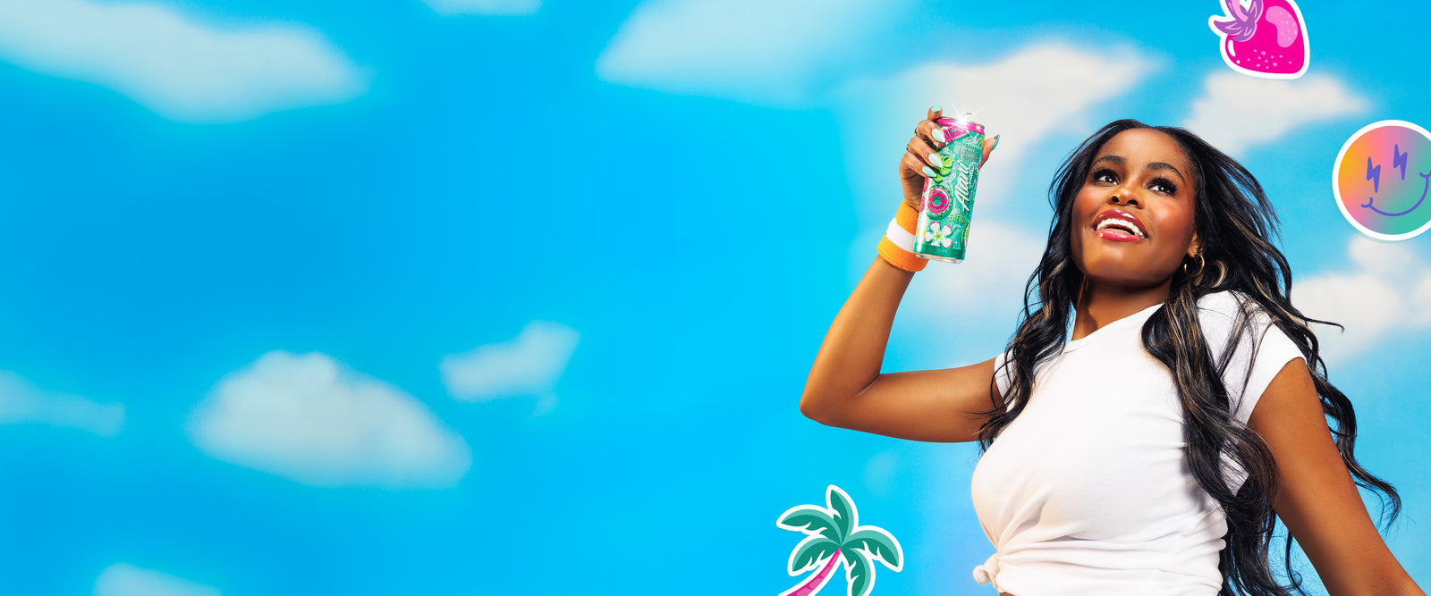 A woman holding a Watermelon Wave Alani Nu Energy drink against a blue sky.