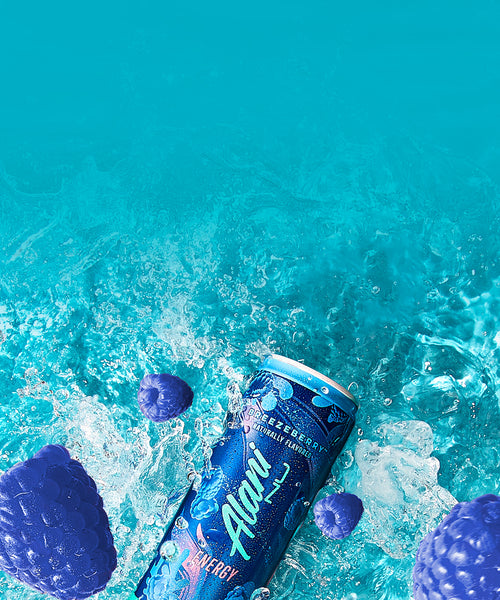 A sugar-free Breezeberry Alani Nu Energy Drink and juicy blue raspberries splashing into crisp, refreshing water.
