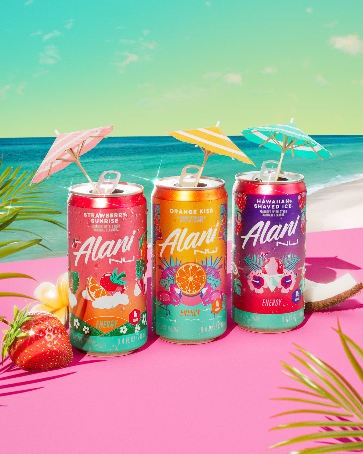 Alani Nu&#39;s zero-sugar Strawberry Sunrise, Orange Kiss, and Hawaiian Shaved Ice Mini Energy Drinks in front of a beachy backdrop.