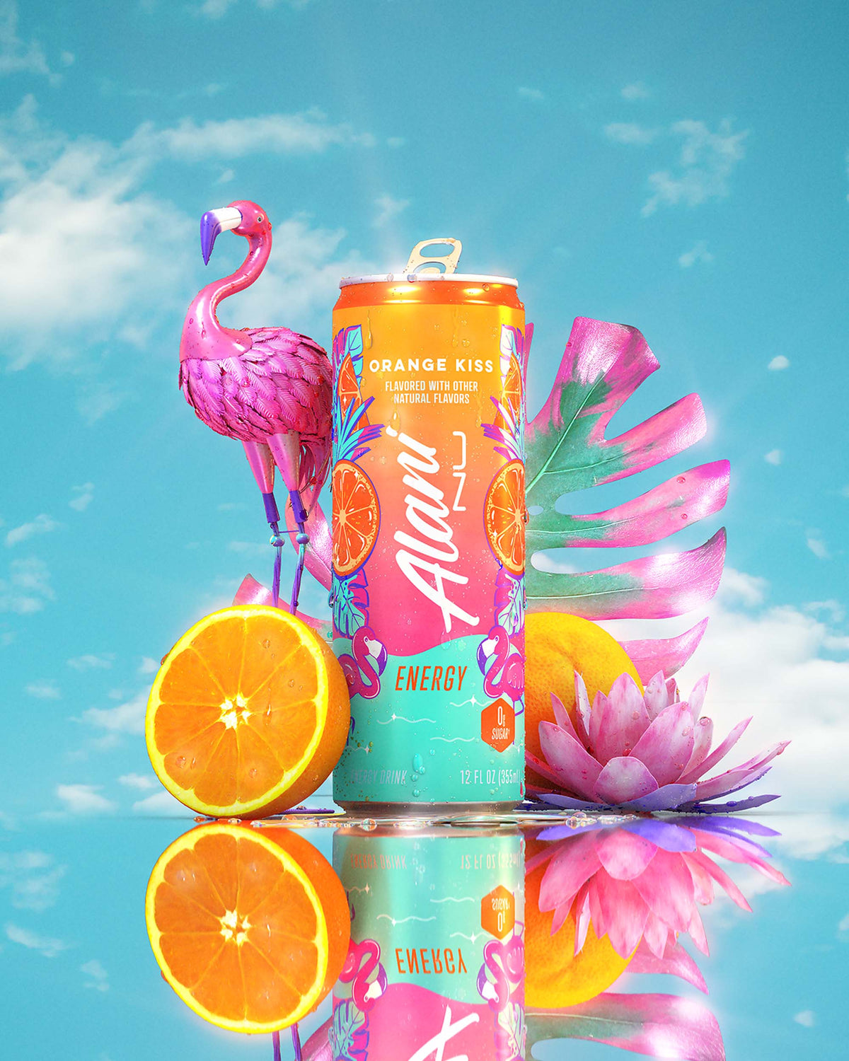 An Orange Kiss Energy Drink, flamingo sculpture, pink florals, and oranges in front of a blue sky. 