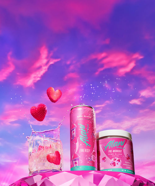 A Pink Slush Bundle atop a pink jewel. To the left, heart-shaped strawberry slices splash into a glass of Pink Slush Energy. 