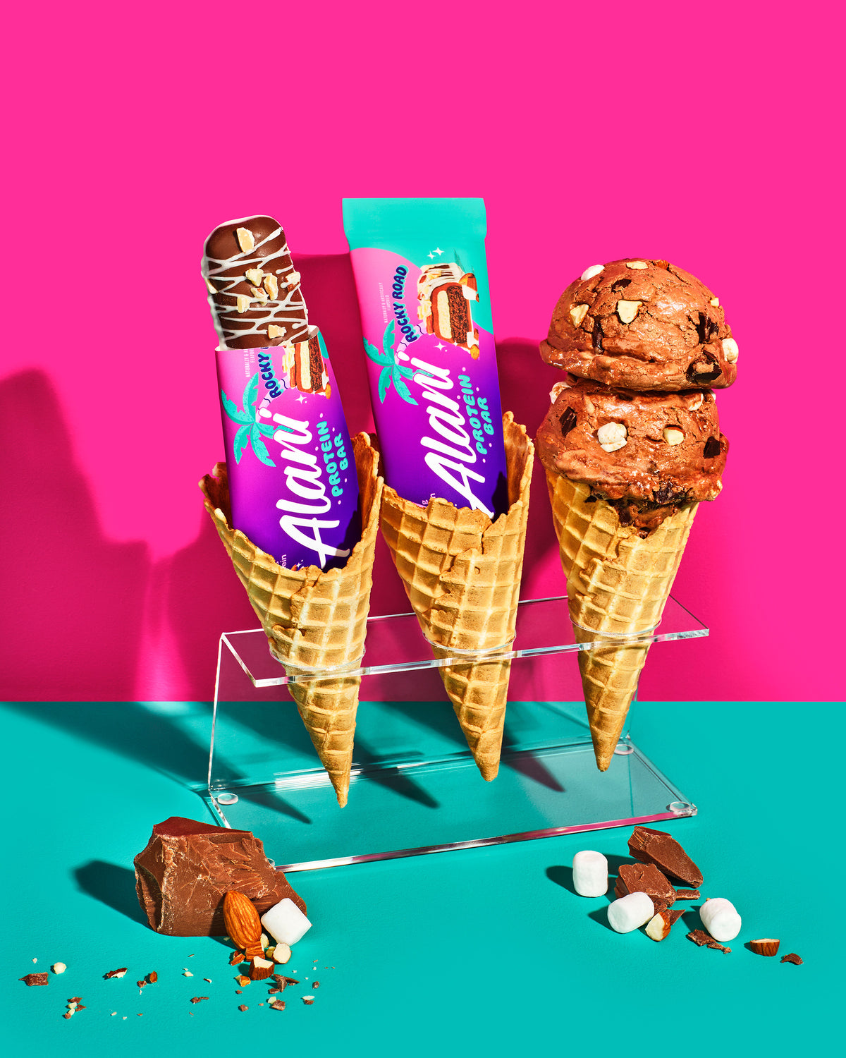 Two Protein Bars in Rocky Road flavor perched next to ice cream cones.