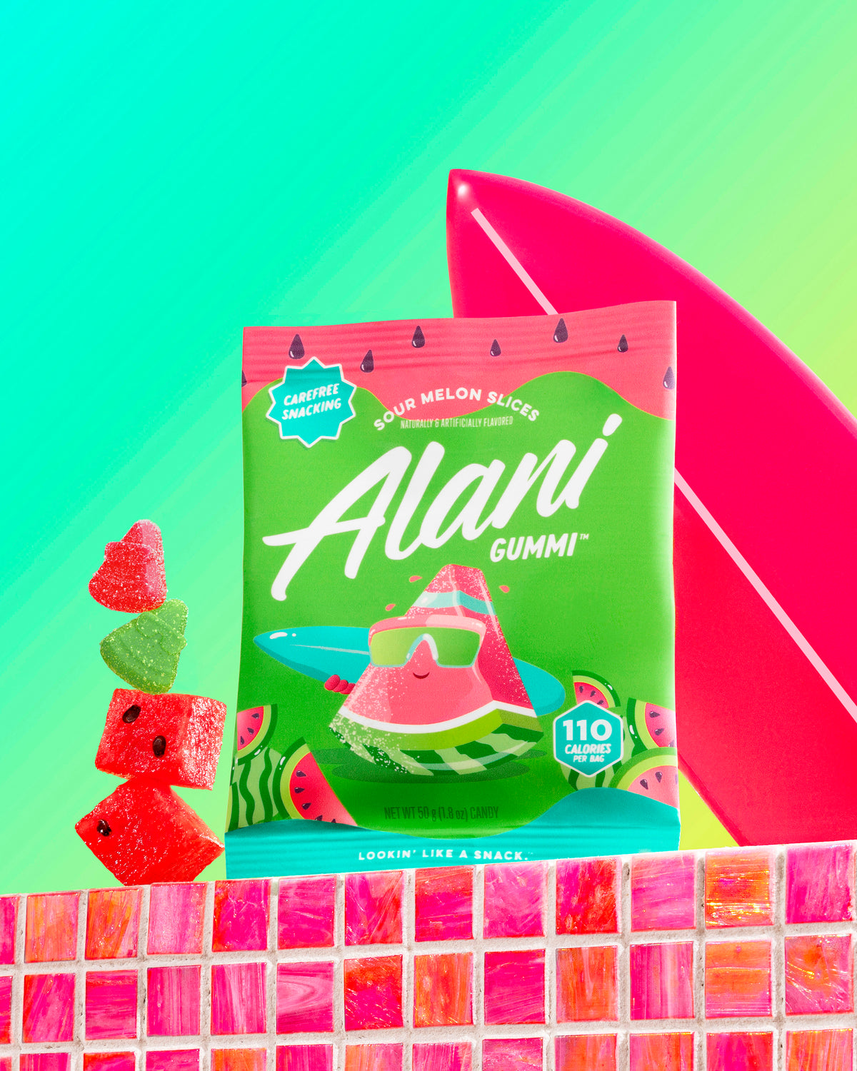 Alani Gummi’s gluten-free Sour Melon Slices stacked on a countertop near a mini surfboard. 