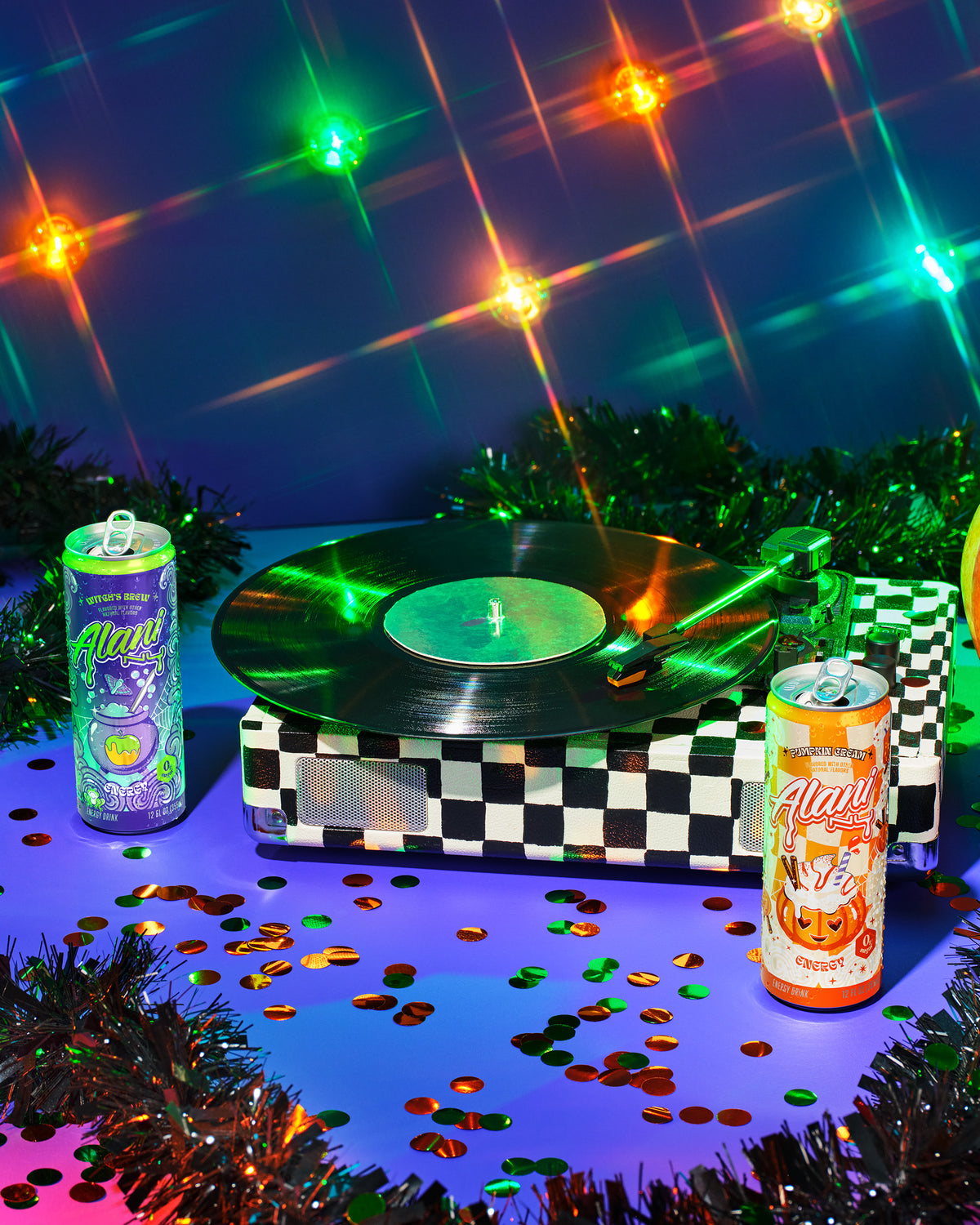 A caramel apple and Alani Nu&#39;s seasonal, zero-sugar Witch&#39;s Brew Energy Drinks, both 12oz and 8.4oz, on a silver platter. 
