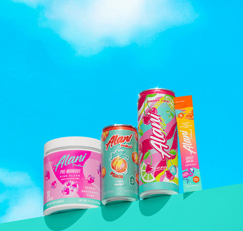 Alani Nu's Pink Slush Pre-Workout, Mini Juicy Peach Energy, Cherry Twist Energy, and an Orange Kiss Energy Stick on a shelf before a bright blue sky.