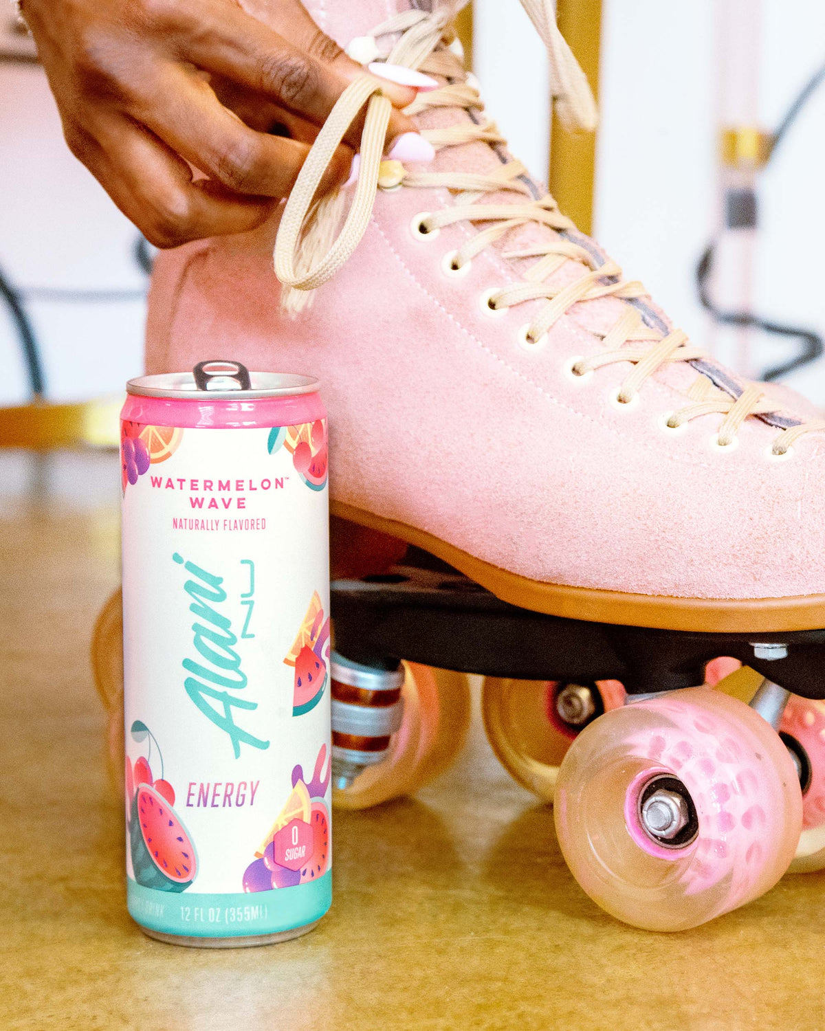 A pink roller skate with a can of Alani Nu&#39;s Watermelon Wave Energy Drink.
