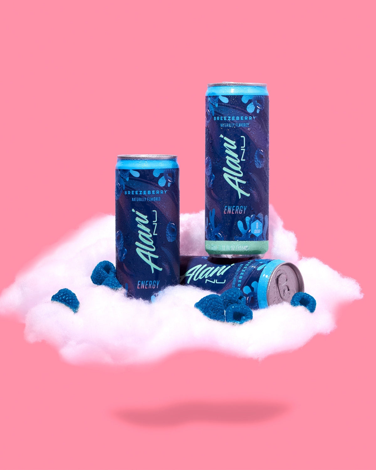 A couple of cans of Energy Drink in Breezeberry flavors sitting on top of a cloud.