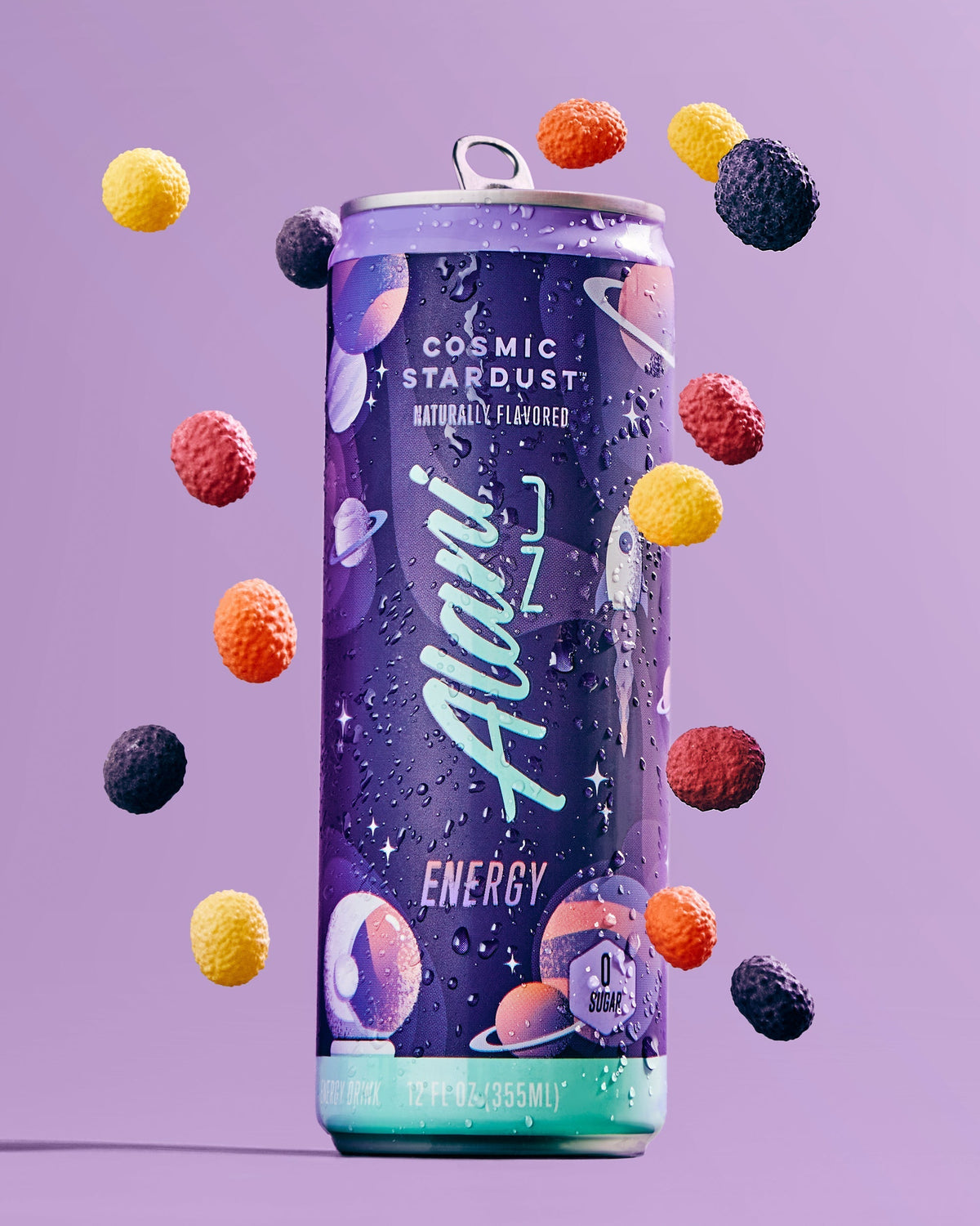 A 12 fl oz can of Cosmic Stardust energy drink by Alani Nu surrounded by candy.