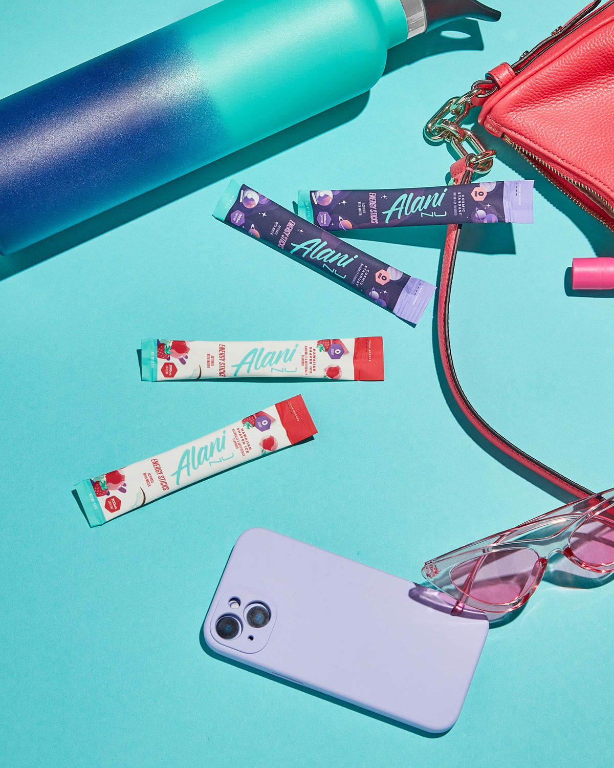 A cell phone, sunglasses, Energy Sticks in Hawaiian Shaved Ice flavor by a wallet.
